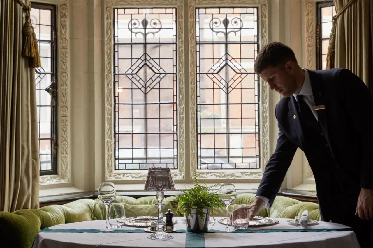 Member of staff in a suit at a laid table, Milestone Hotel Kensington