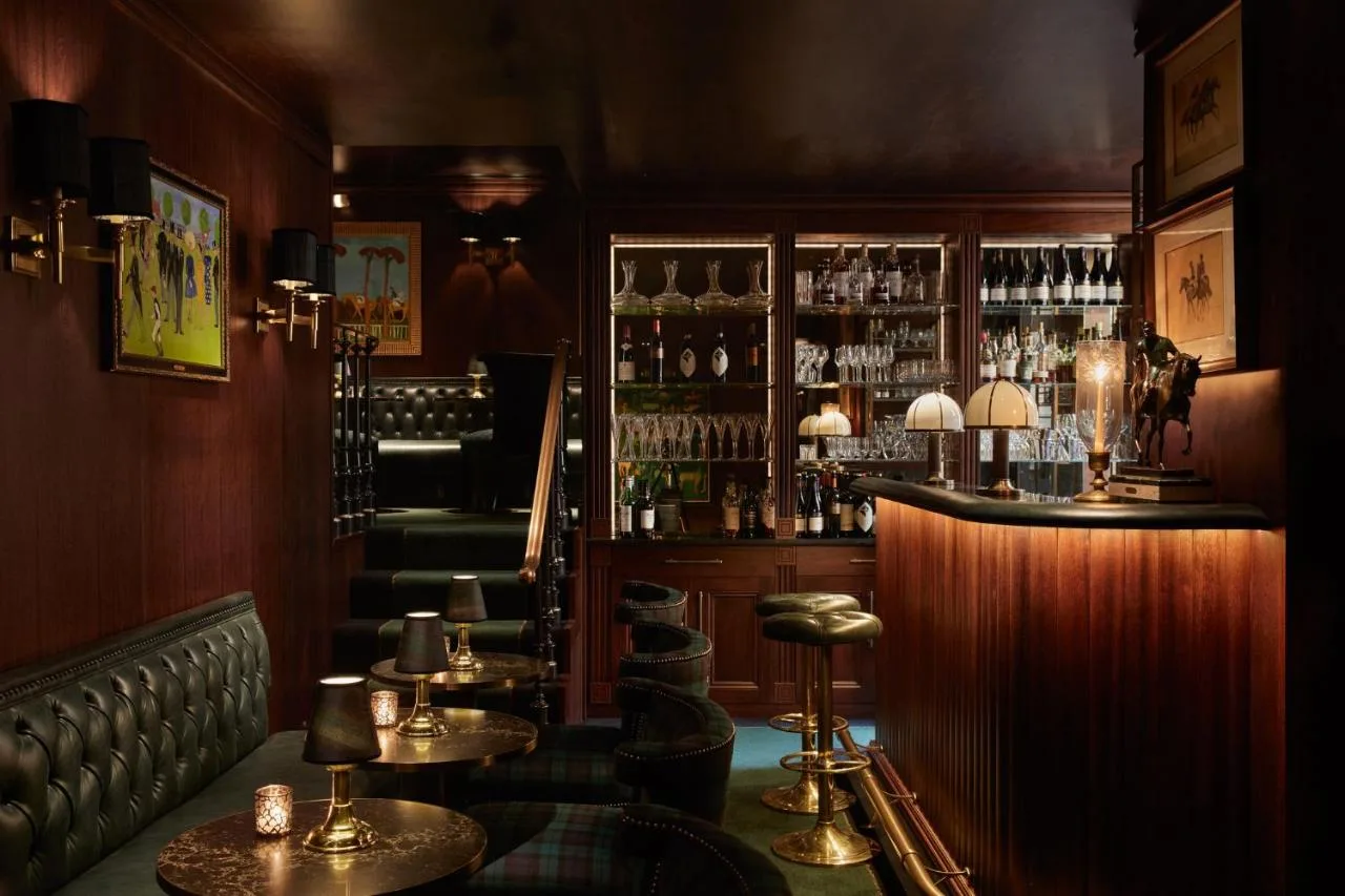 Stables Bar with stools and shelved spirits at Milestone Hotel Kensington