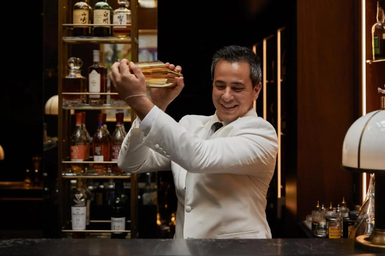 Bartender holding a stack of sandwiches at Milestone Hotel Kensington